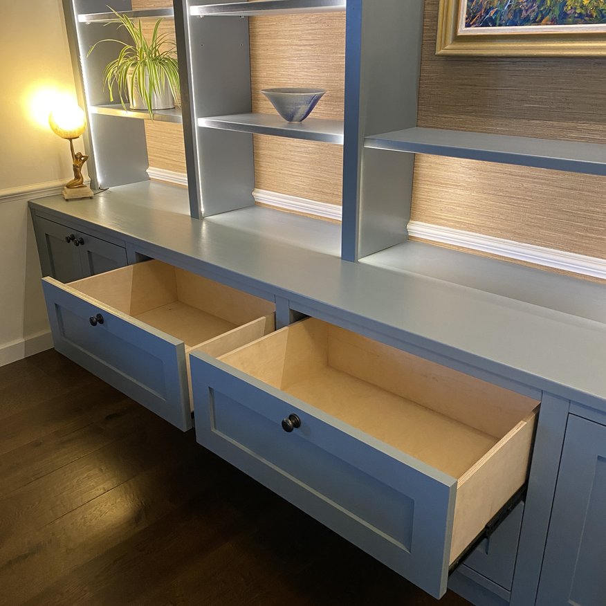 Birch ply drawers built into a media wall with led lighting